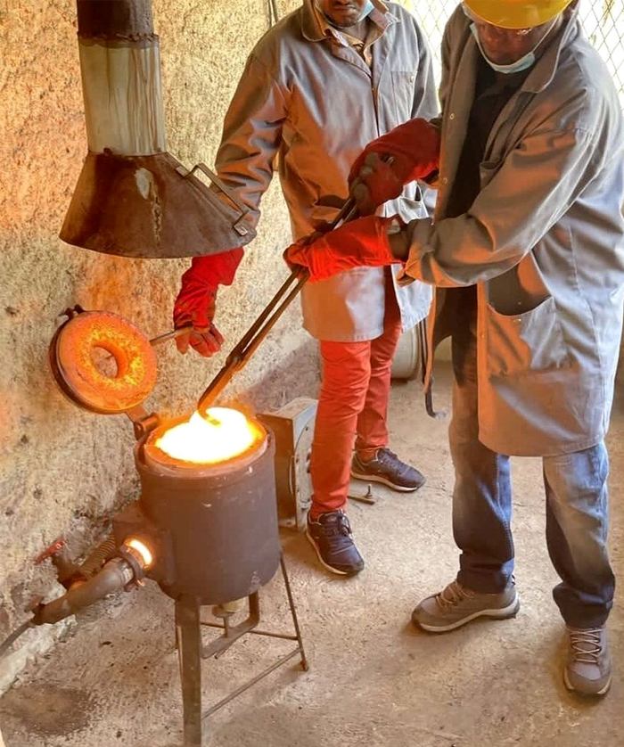 Molten gold poured from a crucible during smelting